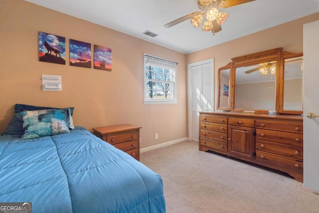 carpeted bedroom featuring ceiling fan and a closet