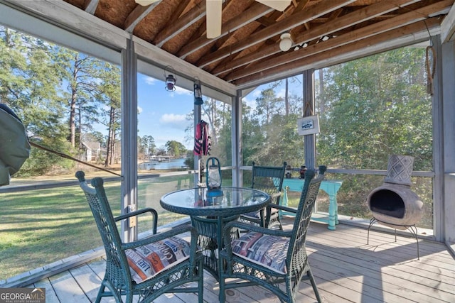 sunroom / solarium featuring a water view