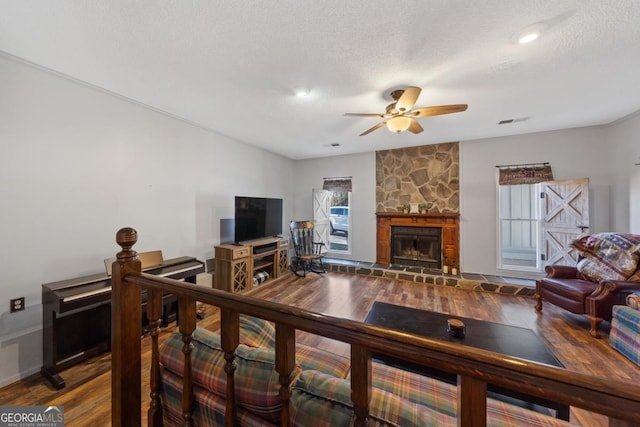 living room featuring hardwood / wood-style floors, a textured ceiling, and a healthy amount of sunlight