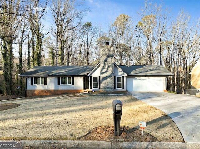 ranch-style house featuring a garage and a front yard