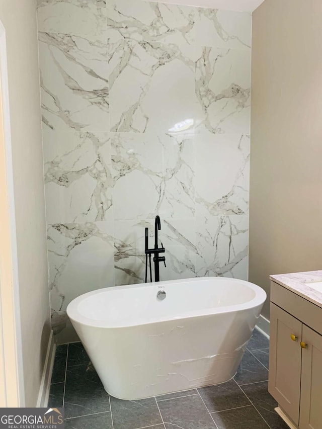 bathroom featuring a tub to relax in and vanity