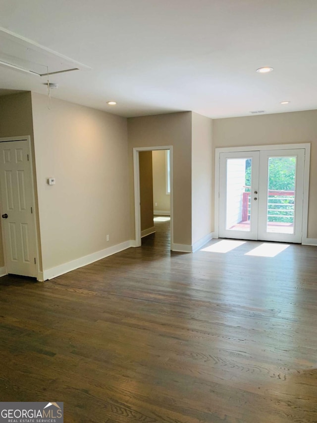 empty room featuring dark wood-type flooring and french doors