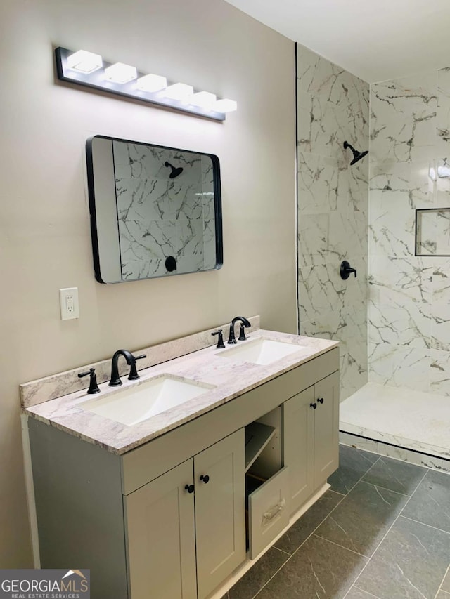 bathroom with vanity and tiled shower