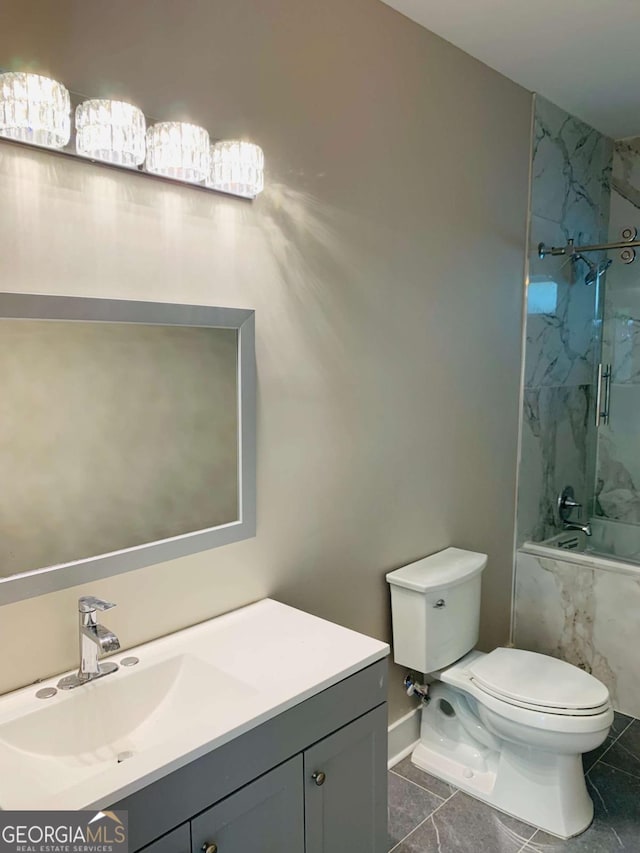 full bathroom with toilet, tiled shower / bath combo, and vanity