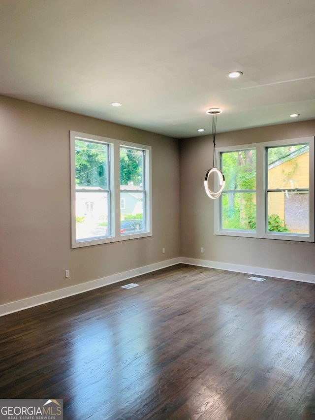 empty room with dark wood-type flooring