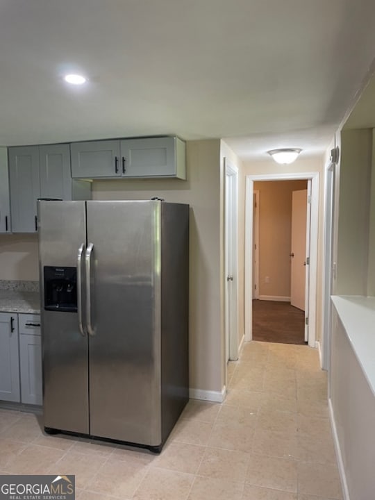 kitchen featuring stainless steel fridge and gray cabinets