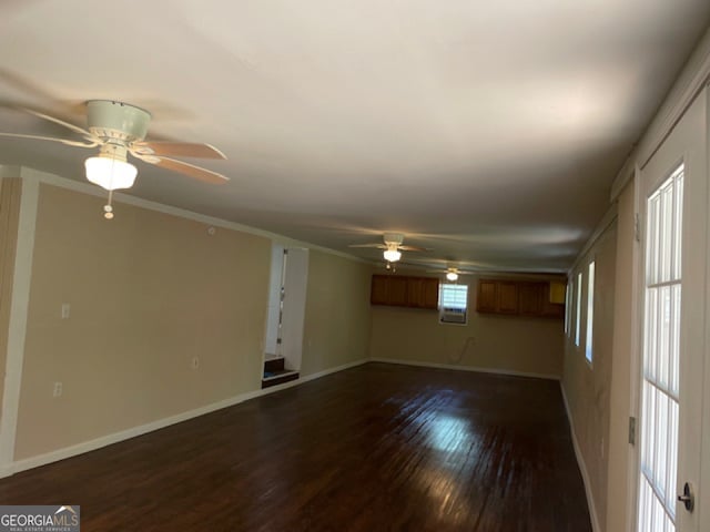 unfurnished living room with ornamental molding and dark hardwood / wood-style floors