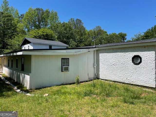 view of side of property featuring a yard