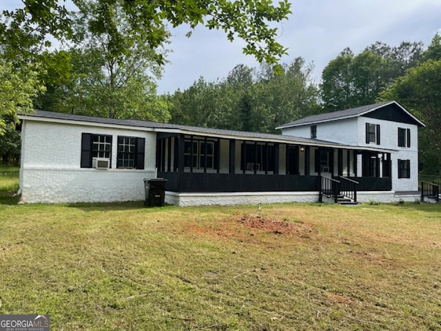 back of house featuring cooling unit and a lawn