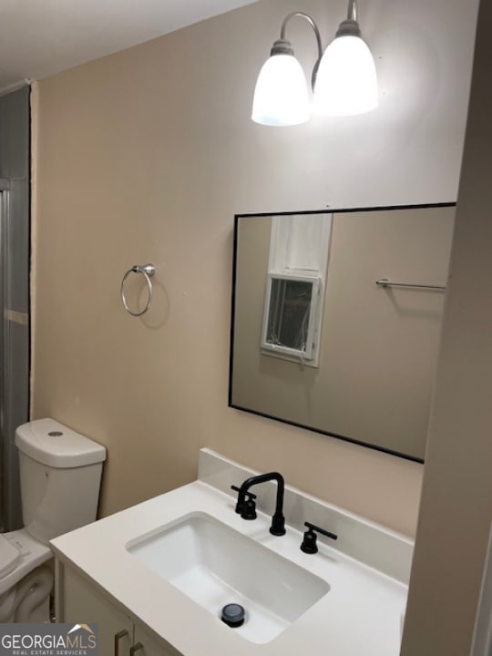 bathroom featuring toilet and vanity