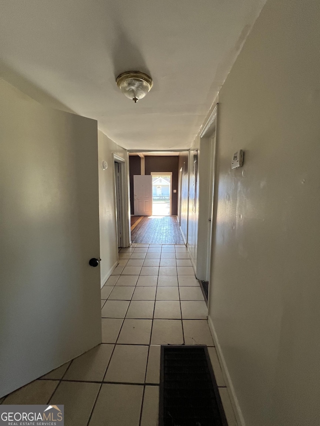 corridor featuring light tile patterned floors