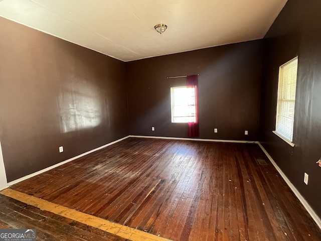 unfurnished room with wood-type flooring