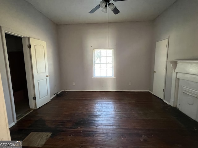 empty room featuring ceiling fan and dark wood-type flooring