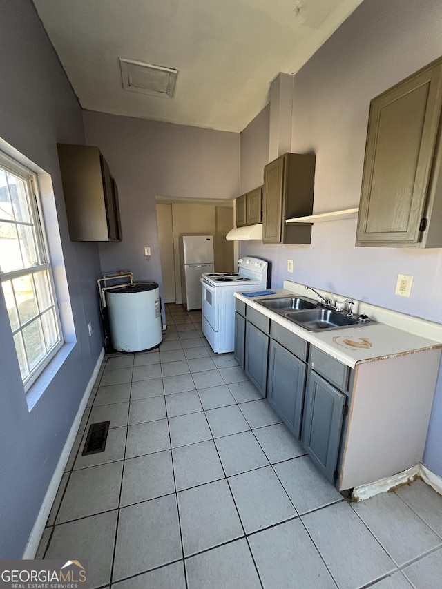 kitchen with light tile patterned floors, sink, white appliances, and gray cabinetry