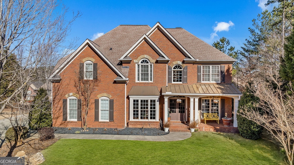 view of front of house featuring a porch and a front yard