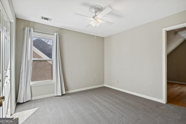 unfurnished bedroom featuring baseboards, a ceiling fan, carpet flooring, and visible vents