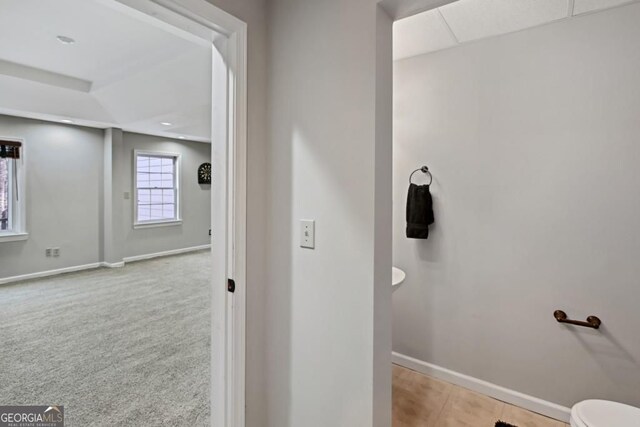 bathroom featuring baseboards and toilet
