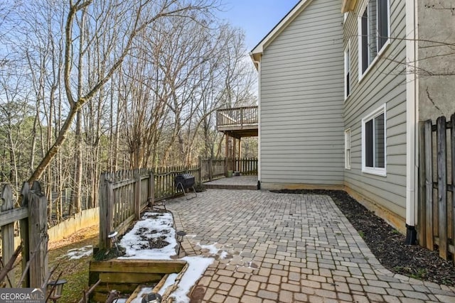view of patio featuring a fenced backyard and a balcony