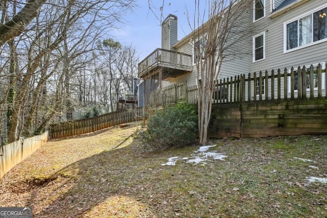 view of yard with a fenced backyard and a balcony