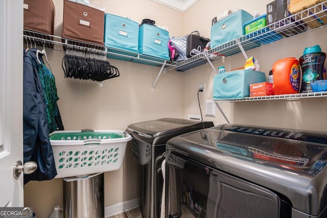 laundry room featuring washer and dryer and ornamental molding