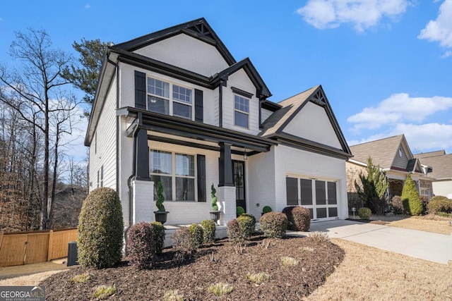 front of property featuring covered porch and a garage