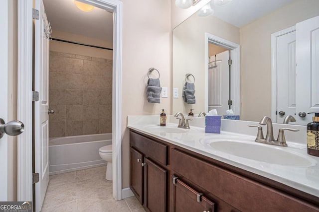 full bathroom featuring vanity, toilet, tile patterned flooring, and tiled shower / bath combo