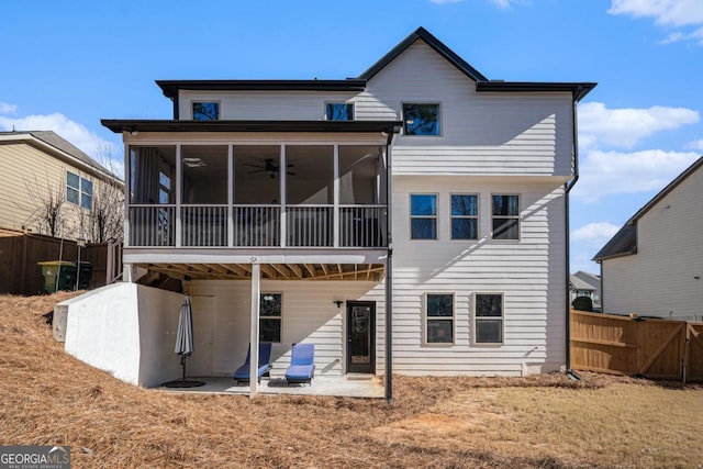 back of house with a sunroom and a patio