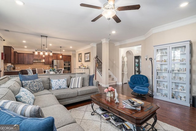 living room featuring hardwood / wood-style flooring, ceiling fan, and ornamental molding