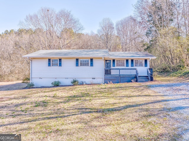 single story home with a deck and a front lawn