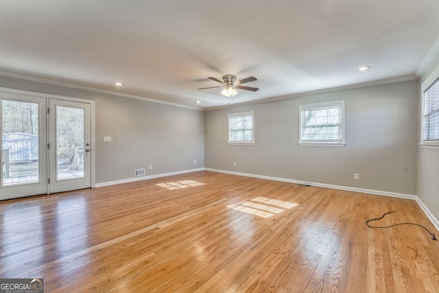 spare room featuring light hardwood / wood-style floors, crown molding, and ceiling fan