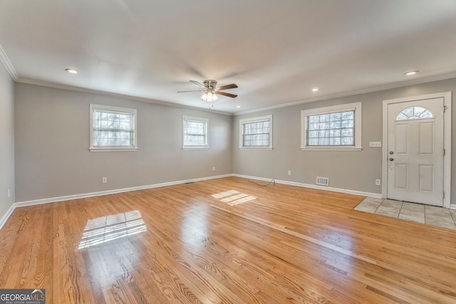 entryway featuring light hardwood / wood-style floors, ceiling fan, and ornamental molding