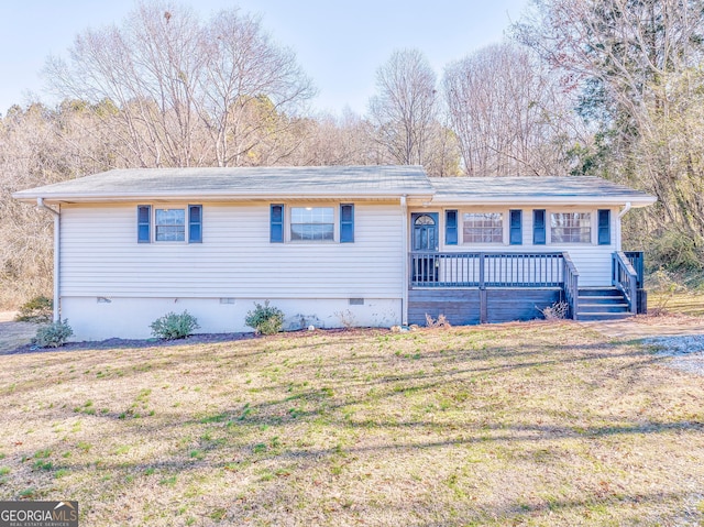 single story home featuring a wooden deck and a front lawn