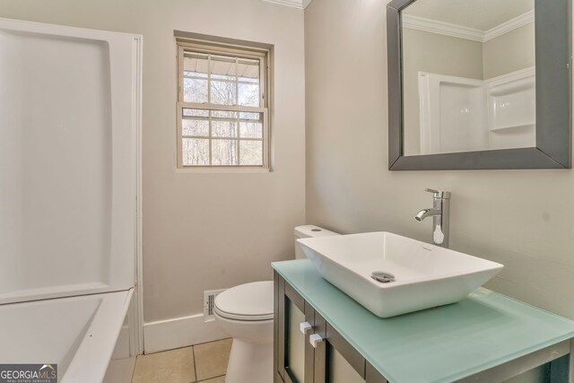 bathroom with vanity, toilet, tile patterned floors, and crown molding