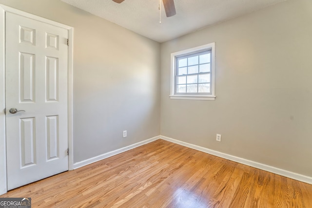 spare room featuring ceiling fan, light hardwood / wood-style floors, and a textured ceiling