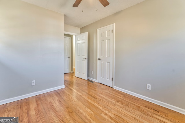 unfurnished bedroom with ceiling fan and light hardwood / wood-style floors