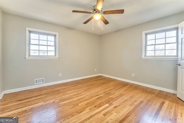 empty room with light hardwood / wood-style floors and ceiling fan