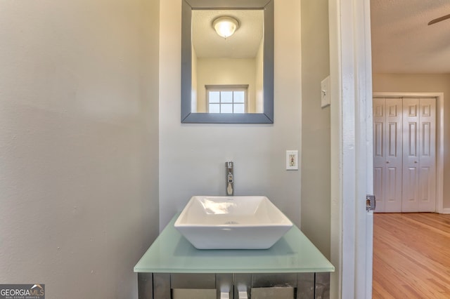 bathroom featuring hardwood / wood-style flooring, a textured ceiling, and vanity