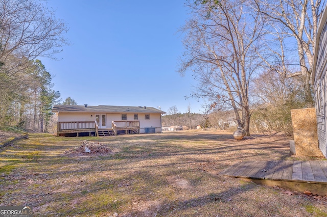 rear view of property with a wooden deck