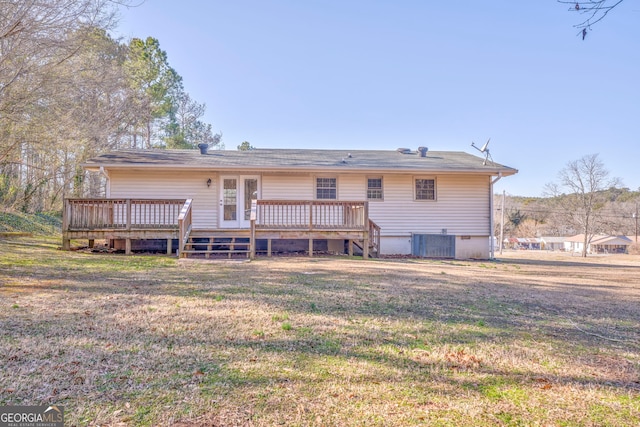 back of house with central air condition unit, a lawn, and a wooden deck