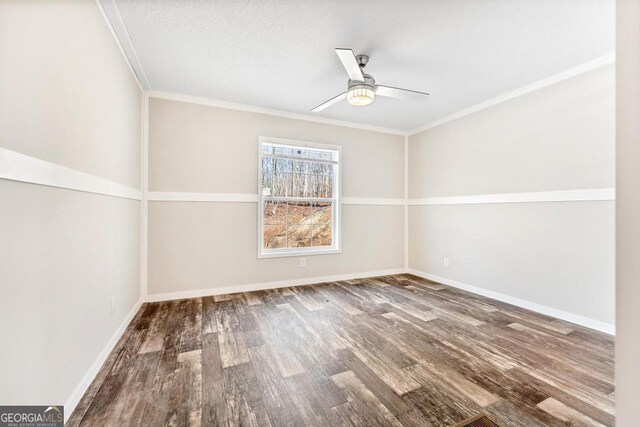 spare room with ceiling fan, hardwood / wood-style flooring, and crown molding