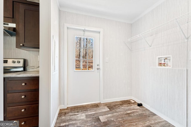 laundry room with dark hardwood / wood-style flooring, ornamental molding, and hookup for a washing machine