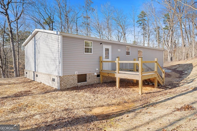 rear view of house featuring a deck