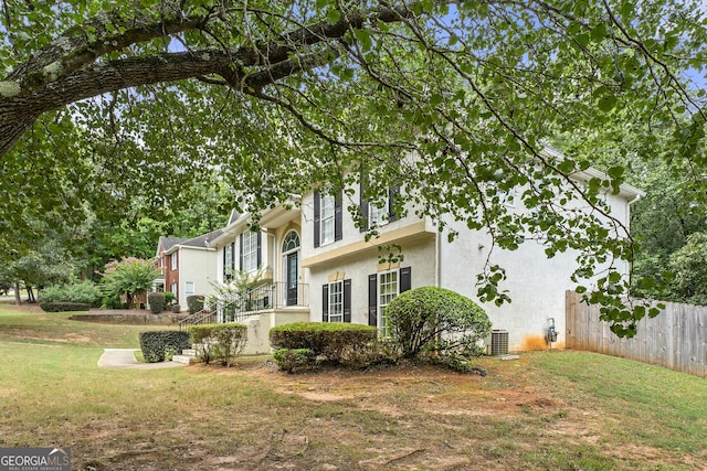 exterior space featuring cooling unit and a yard