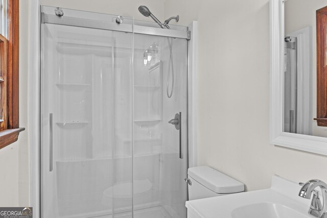 bathroom with vanity, toilet, and a shower with shower door