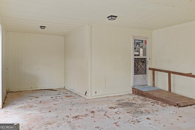 empty room featuring wood walls