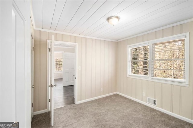 empty room with carpet and crown molding