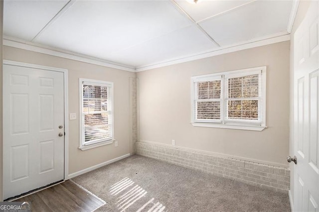 carpeted spare room with crown molding