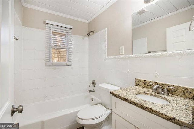 full bathroom with toilet, tiled shower / bath, tile walls, crown molding, and vanity