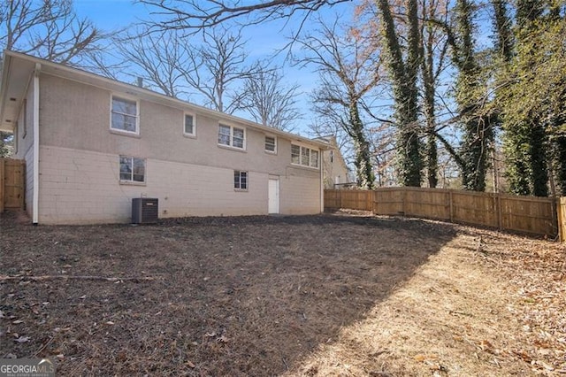 rear view of house featuring central AC unit