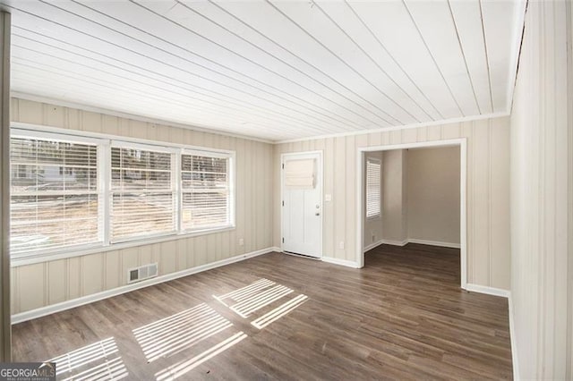 spare room featuring wooden ceiling and dark hardwood / wood-style floors